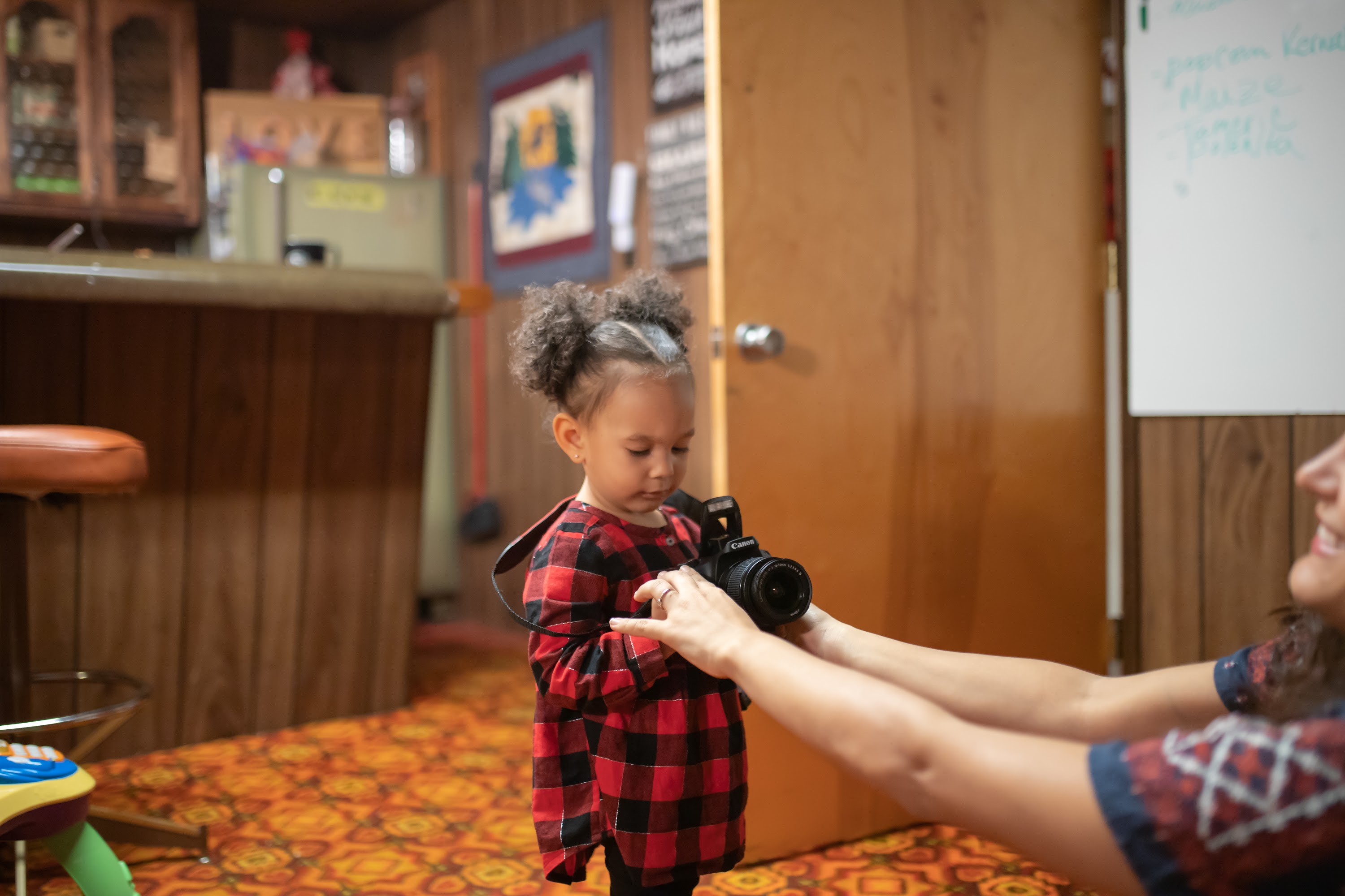 Toddler Holding Camera with Adult's Help