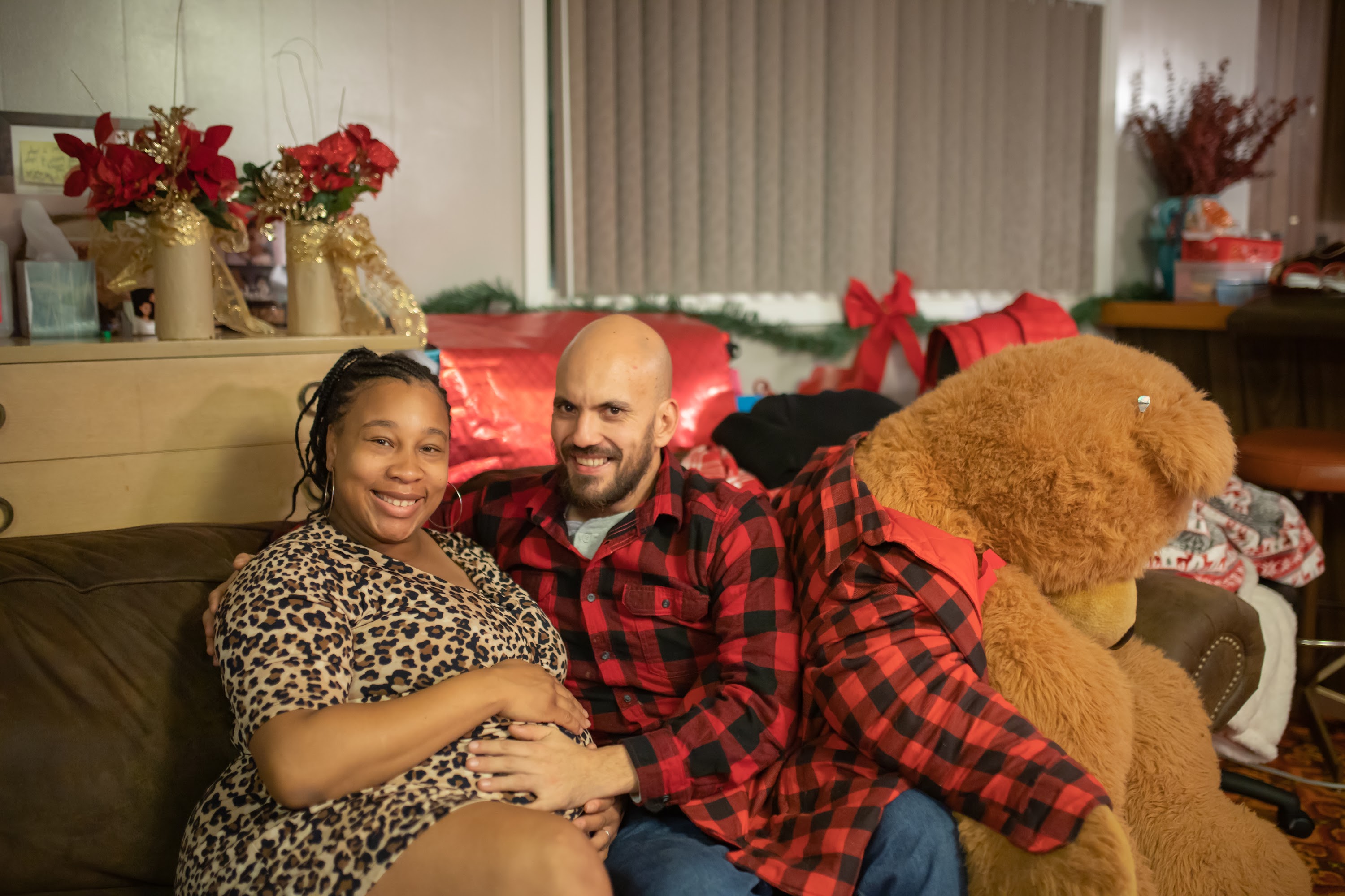Couple's Christmas Celebration with Pregnancy Moment