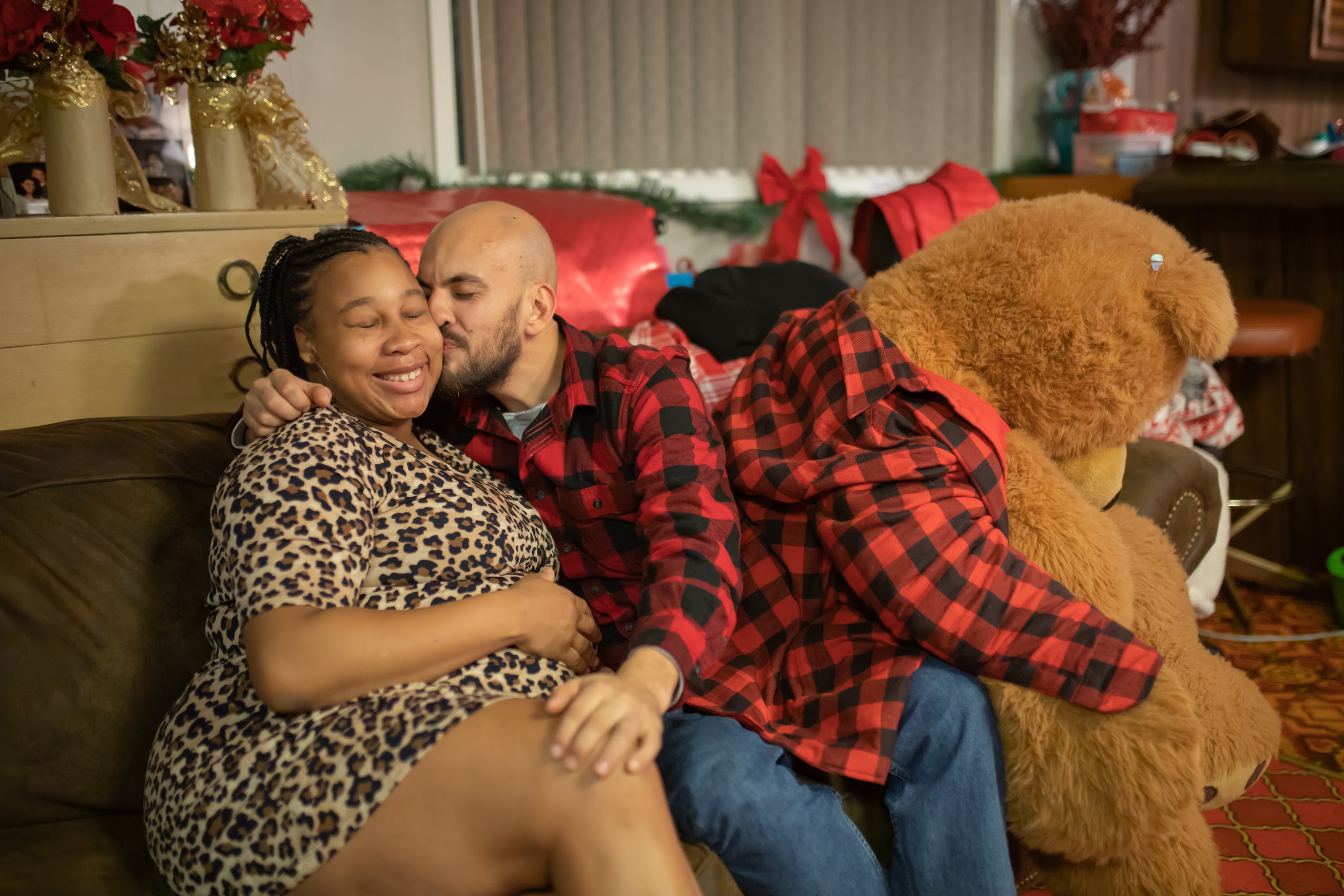 Holiday Couple Embracing with Giant Teddy Bear