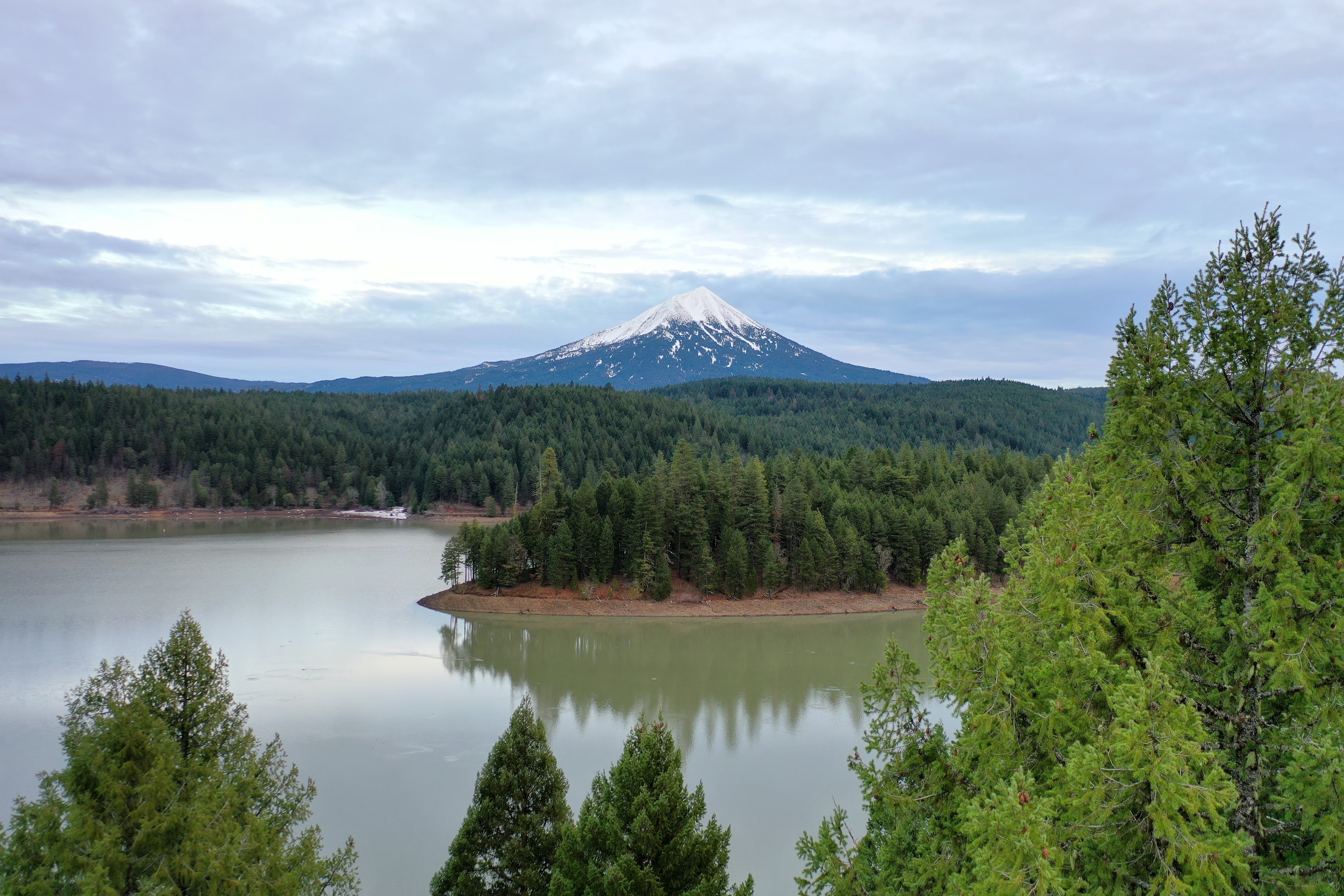 Snow-Capped Mountain Over Lake and Forest