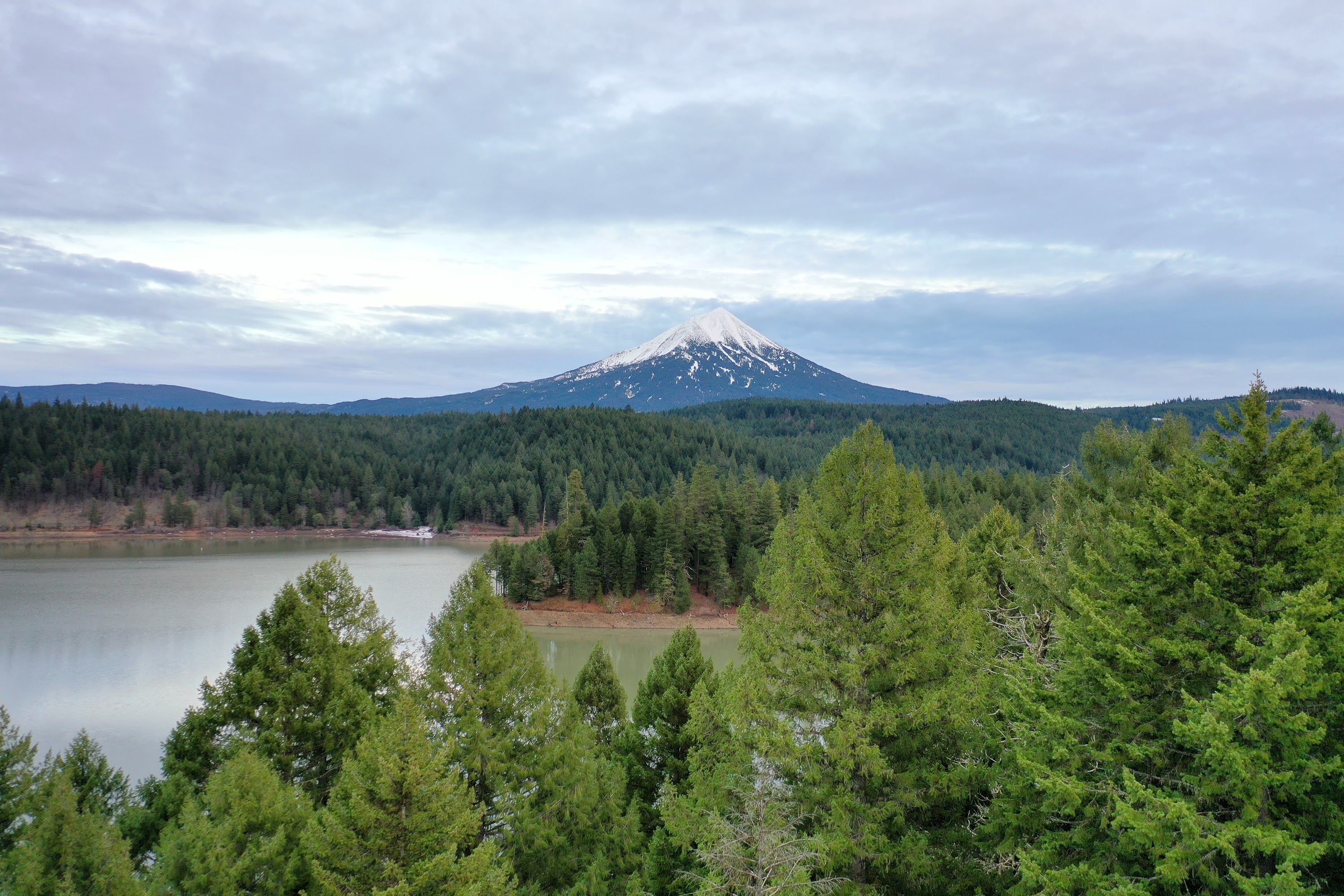 Snow-Capped Mountain Over Lake and Forest