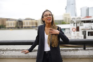 Smiling Woman in Pinstripe Blazer in European Cobblestone Alley