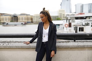 Smiling Woman in Pinstripe Blazer in European Cobblestone Alley