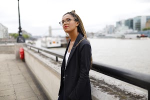 Smiling Woman in Pinstripe Blazer in European Cobblestone Alley