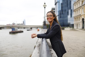 Smiling Woman in Pinstripe Blazer in European Cobblestone Alley