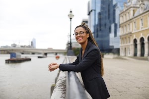 Smiling Woman in Pinstripe Blazer in European Cobblestone Alley