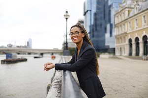 Smiling Woman in Pinstripe Blazer in European Cobblestone Alley
