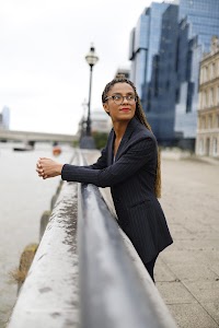 Smiling Woman in Pinstripe Blazer in European Cobblestone Alley