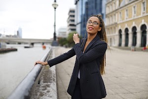 Smiling Woman in Pinstripe Blazer in European Cobblestone Alley