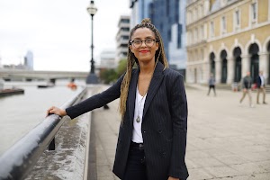 Smiling Woman in Pinstripe Blazer in European Cobblestone Alley