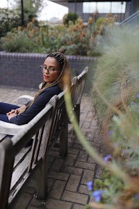 Smiling Woman in Pinstripe Blazer in European Cobblestone Alley