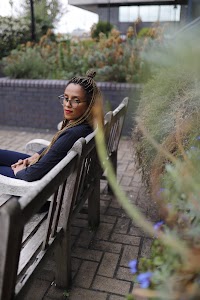 Smiling Woman in Pinstripe Blazer in European Cobblestone Alley