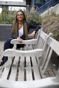 Smiling Woman in Pinstripe Blazer in European Cobblestone Alley