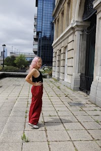 Young Woman with Pink Hair Posing on Urban Brick Plaza