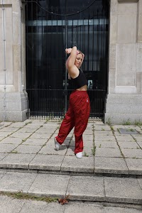 Young Woman with Pink Hair Posing on Urban Brick Plaza