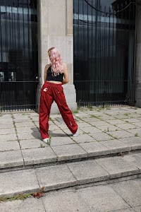 Young Woman with Pink Hair Posing on Urban Brick Plaza