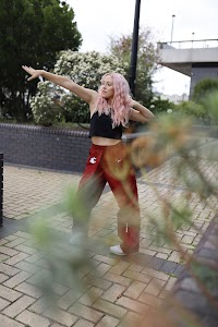 Young Woman with Pink Hair Posing on Urban Brick Plaza