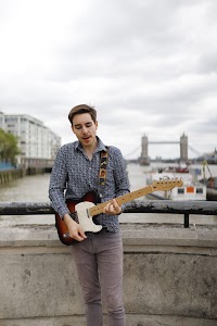 Guitarist Portrait on the Thames Embankment with Tower Bridge
