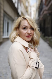 Blonde Woman in Beige Trench Coat on Cobblestone Alley