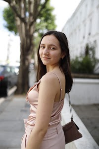 Young Woman in Pink Outfit on Notting Hill Street