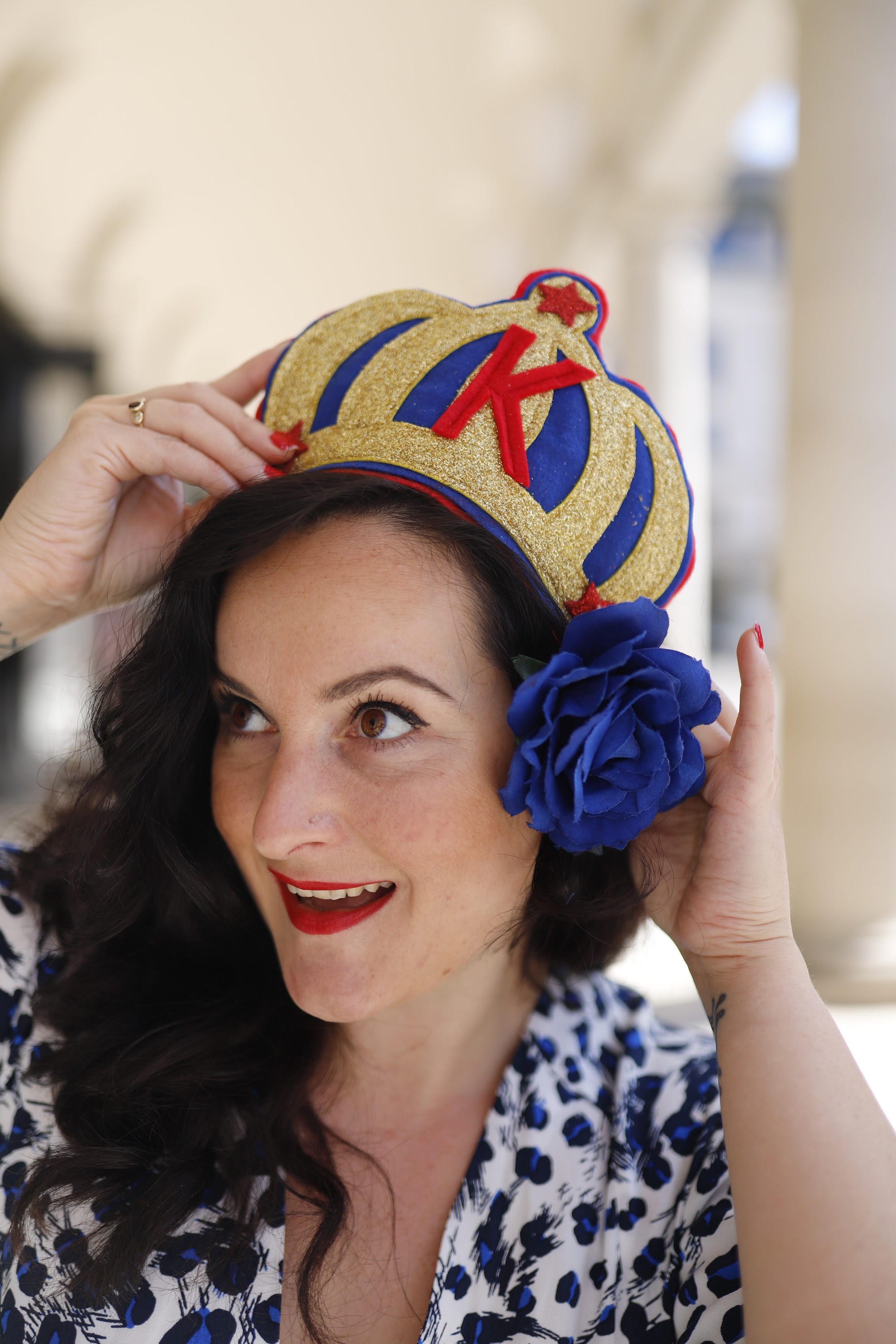 Woman with Crown Headpiece Before Rainbow Backdrop