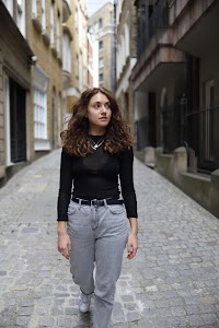 Young Woman on Riverside Bench – Urban Promenade