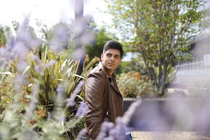 Young Man Resting on Weathered Park Bench