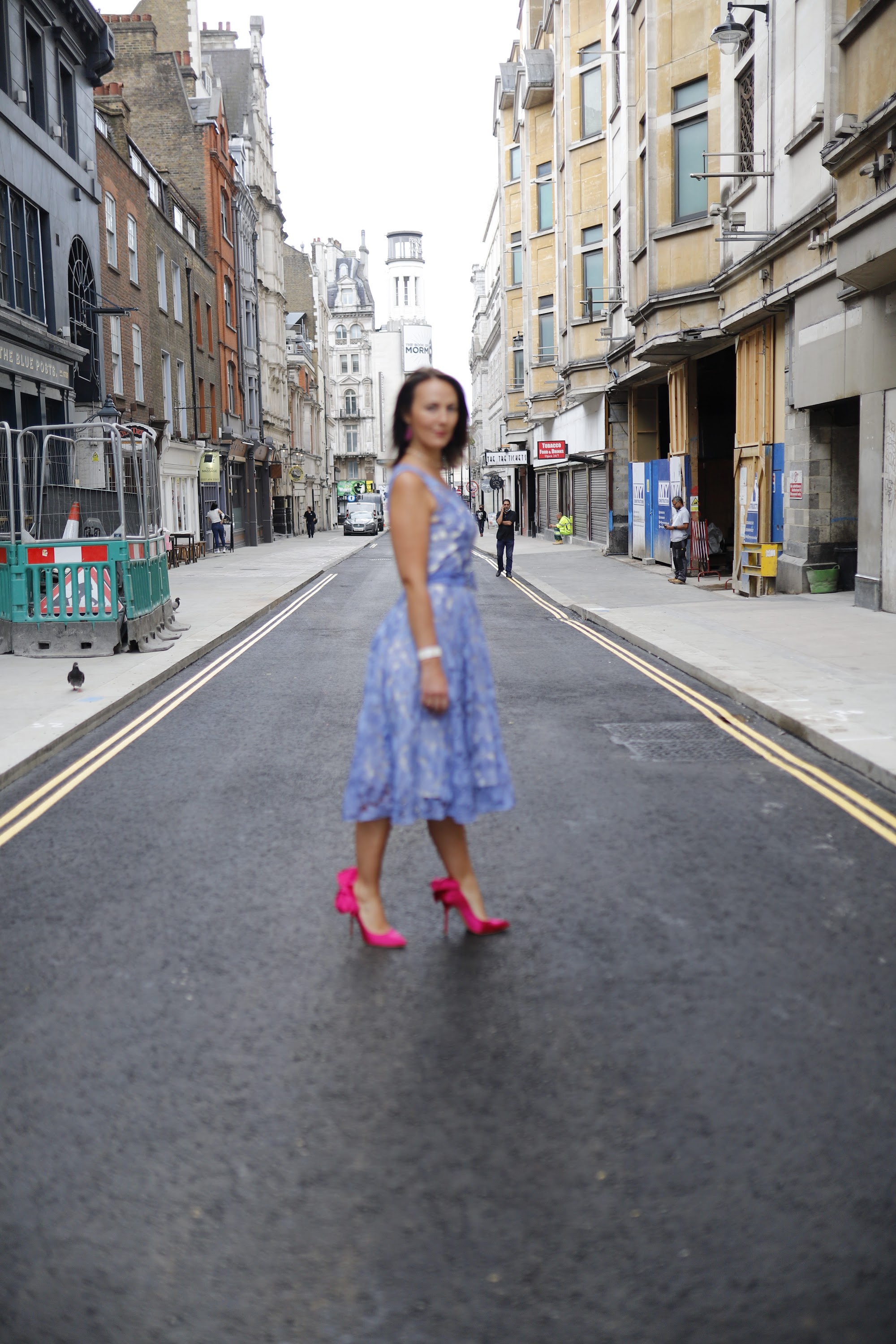 Woman in Blue Lace Dress on London Cobblestone Street