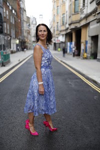 Woman in Blue Lace Dress on London Cobblestone Street