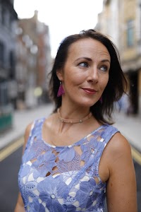 Woman in Blue Lace Dress on London Cobblestone Street