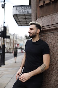 Young Man in Black on Urban Street