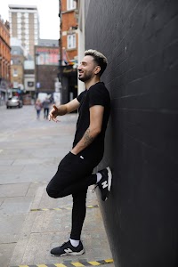 Young Man in Black on Urban Street