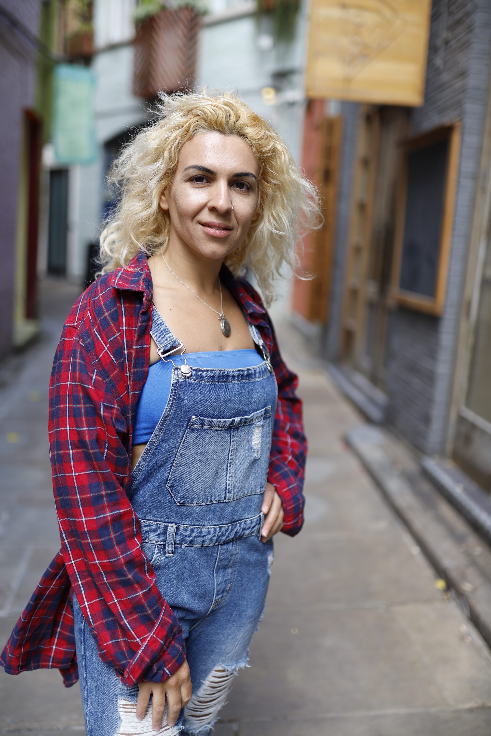 Woman Seated on Bench Outside Urban Shopfront