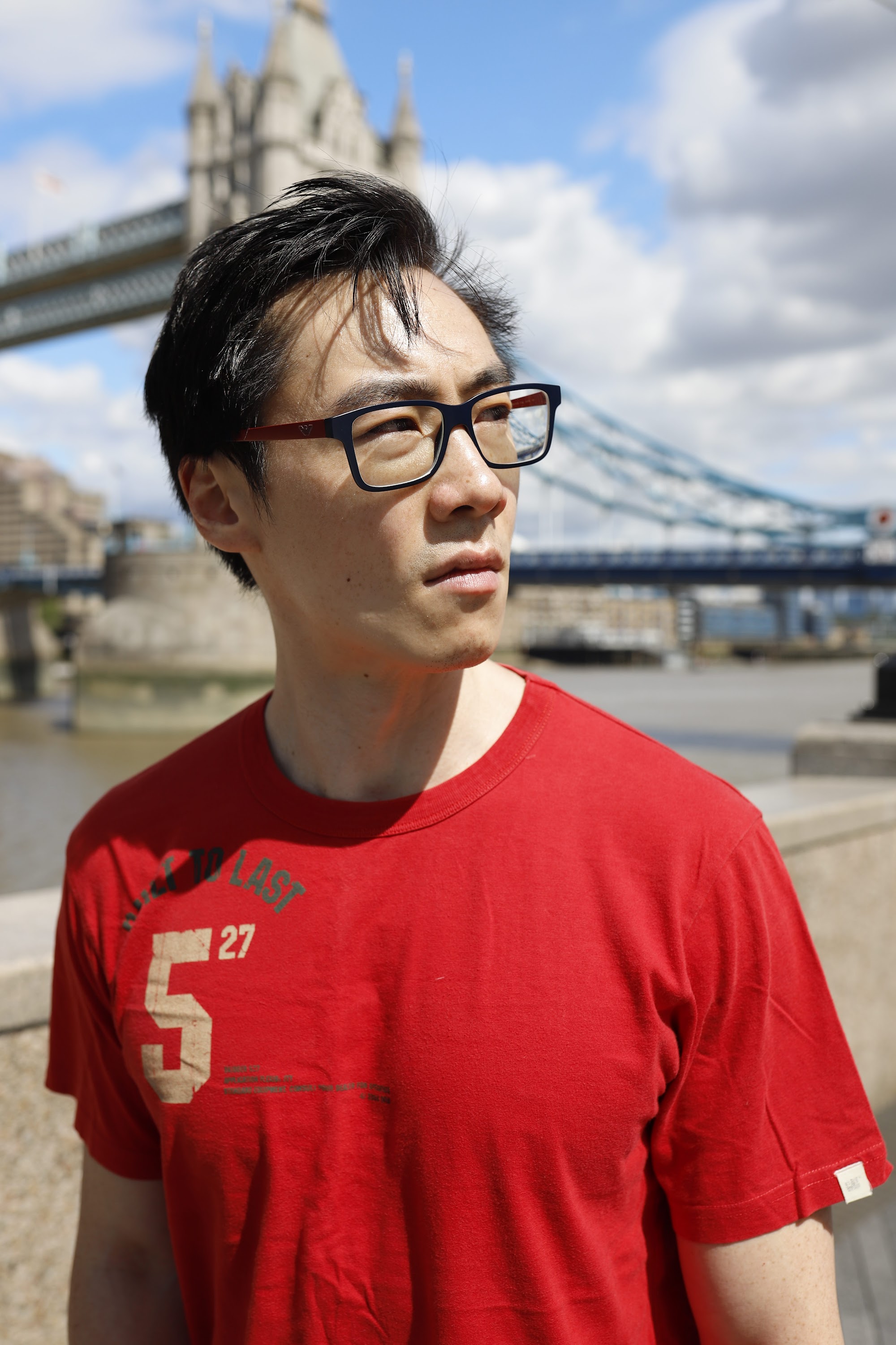 Young Man in Red T-Shirt on Urban Street