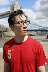 Young Man in Red T-Shirt on Urban Street