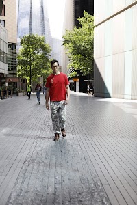 Young Man in Red T-Shirt on Urban Street