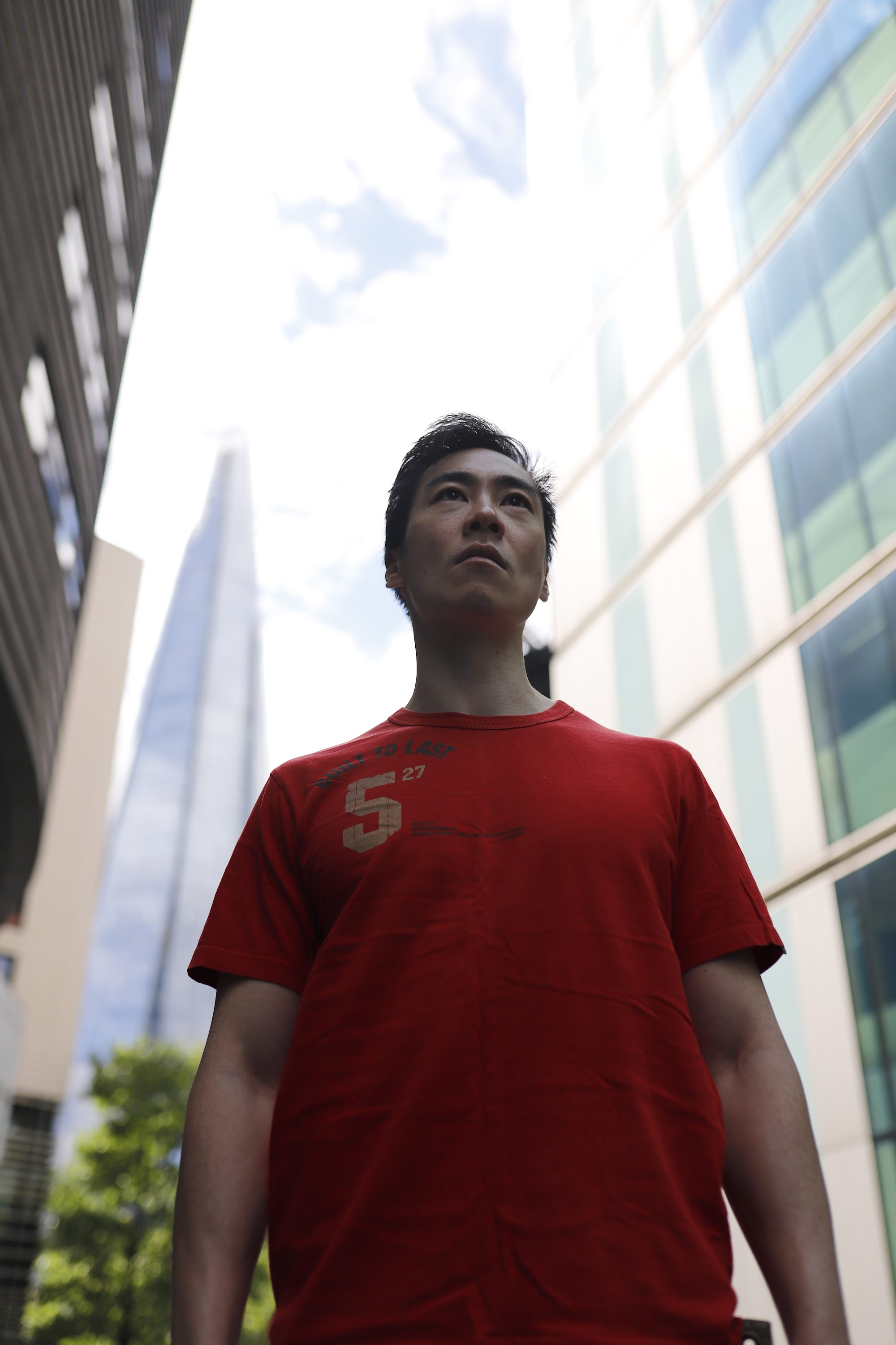 Young Man in Red T-Shirt on Urban Street