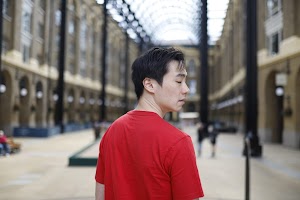 Young Man in Red T-Shirt on Urban Street