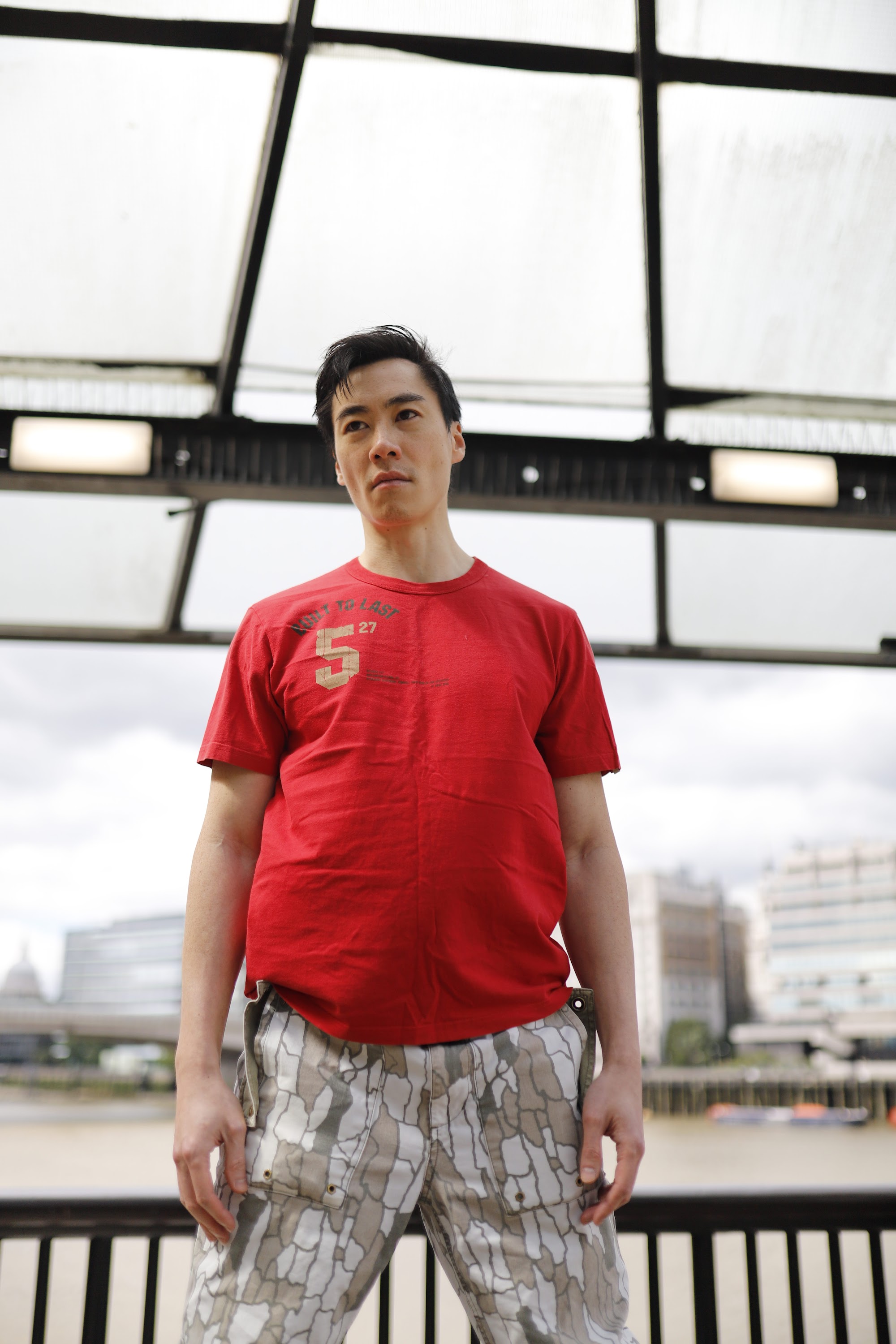 Young Man in Red T-Shirt on Urban Street