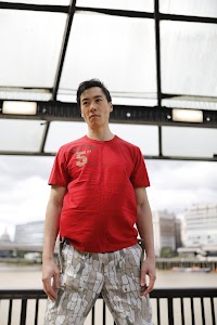 Young Man in Red T-Shirt on Urban Street