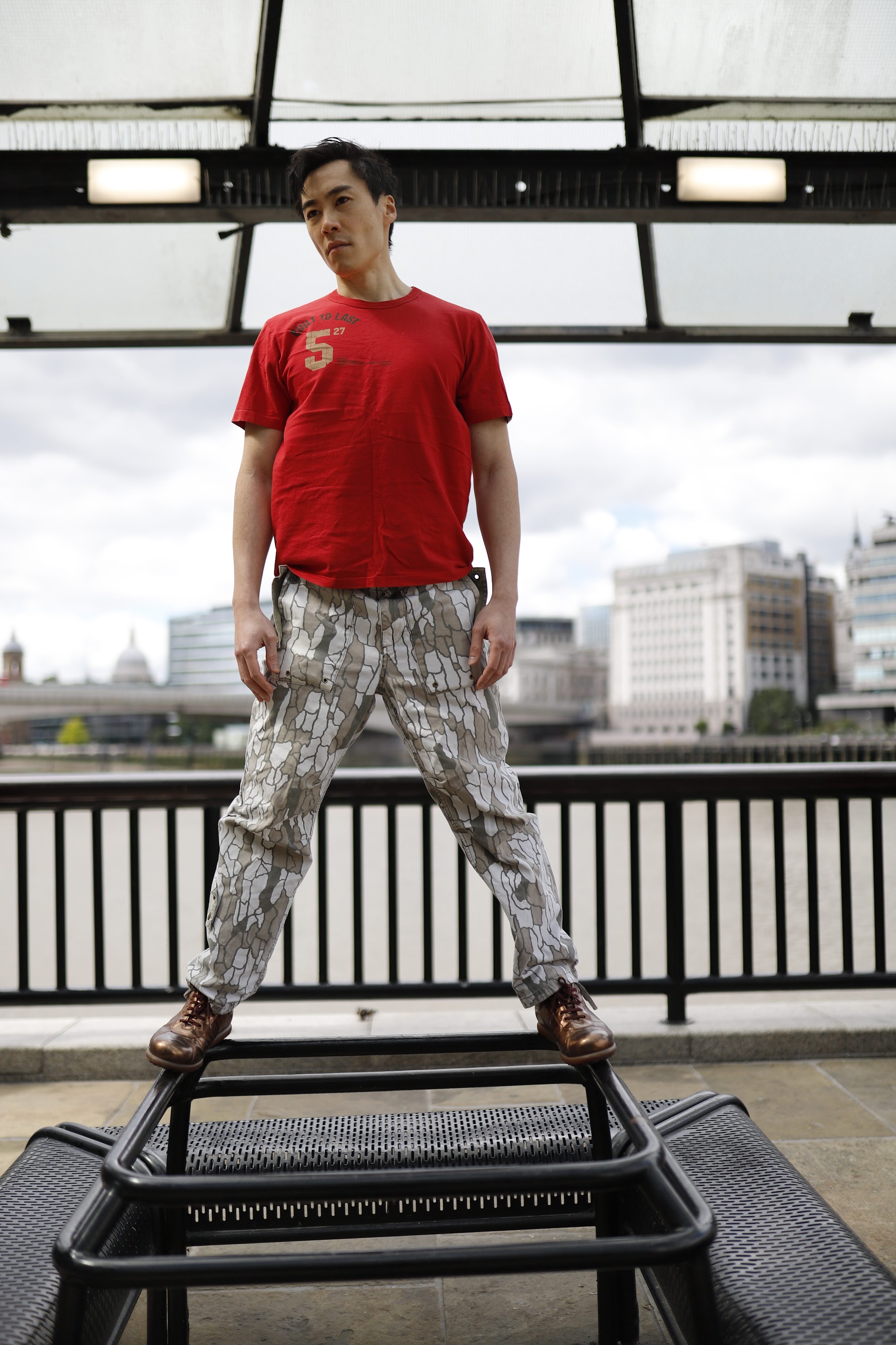 Young Man in Red T-Shirt on Urban Street
