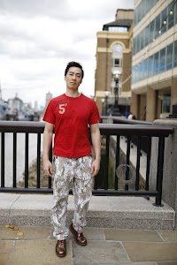 Young Man in Red T-Shirt on Urban Street