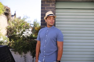 Man in Panama Hat Walking on a London Street