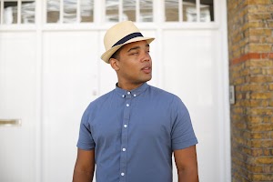 Man in Panama Hat Walking on a London Street