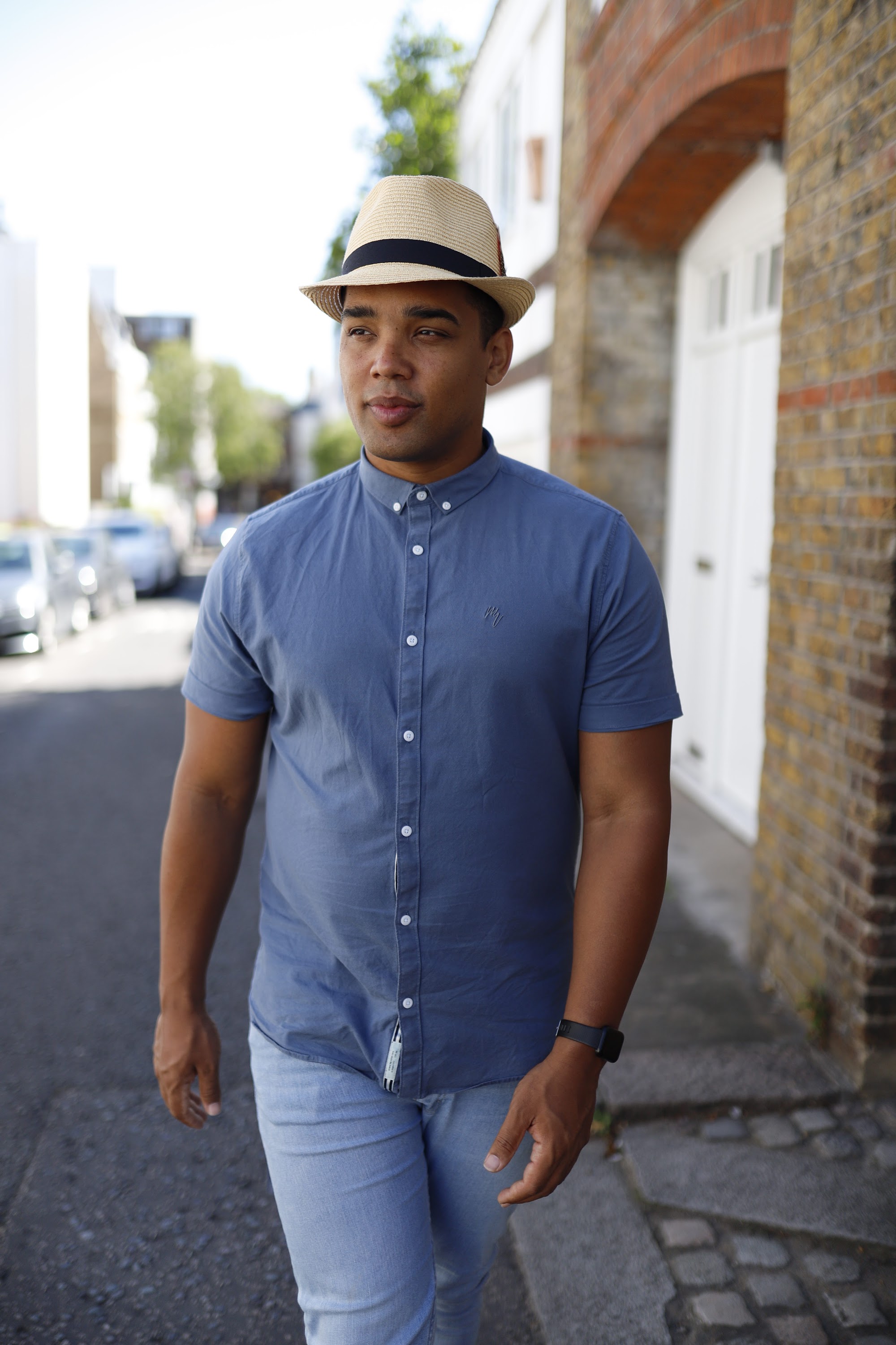 Man in Panama Hat Walking on a London Street