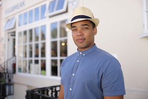 Man in Panama Hat Walking on a London Street