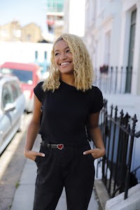 Young Woman Posing on Pastel Terraced Street