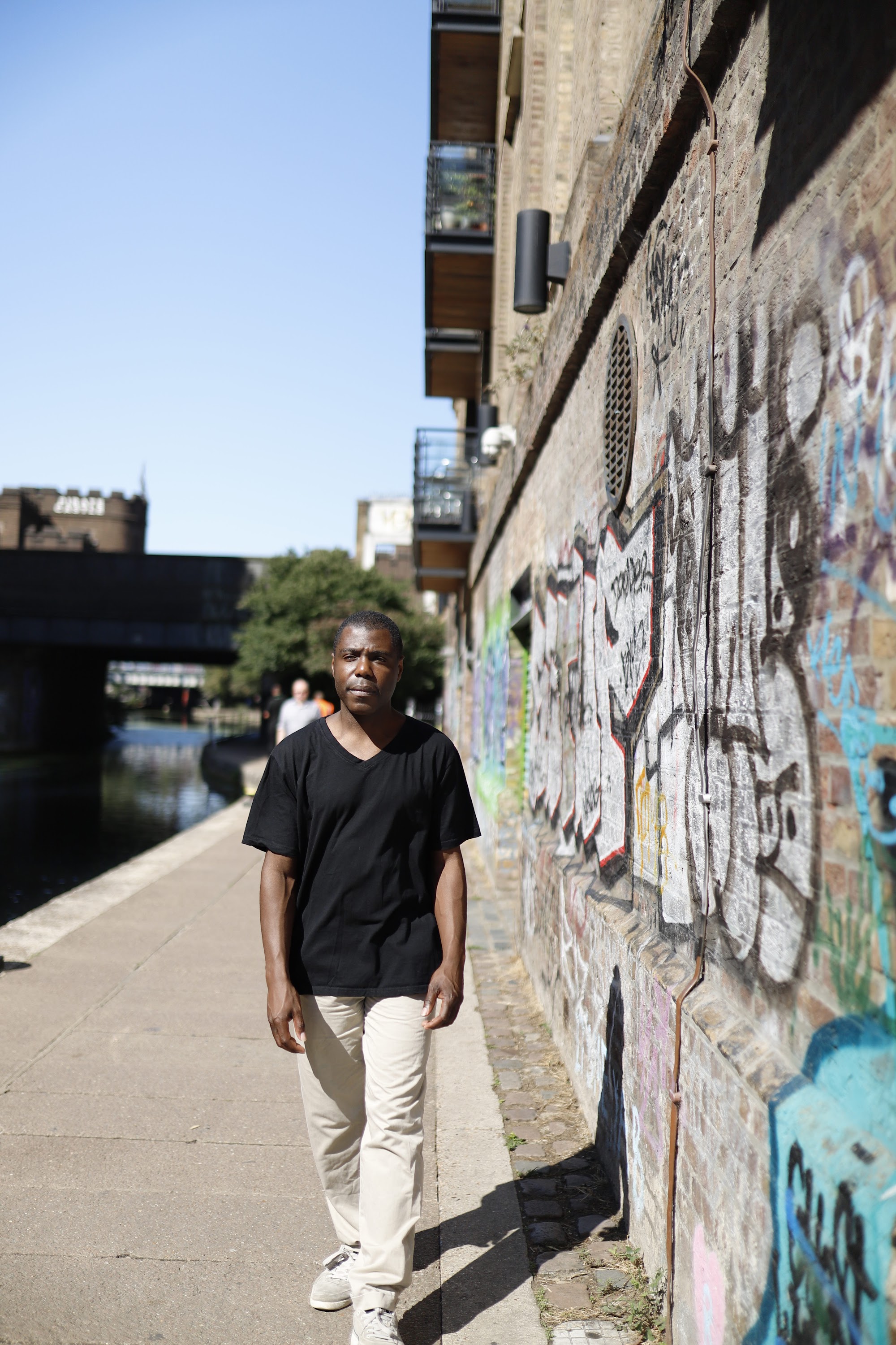 Man Leaning on Canal Bridge Railing