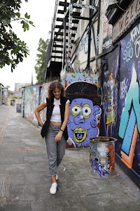 Young Woman Portrait in Urban Tunnel with Graffiti Wall