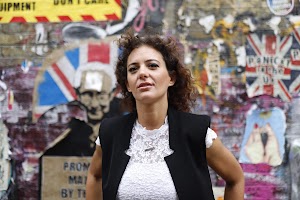 Young Woman Portrait in Urban Tunnel with Graffiti Wall